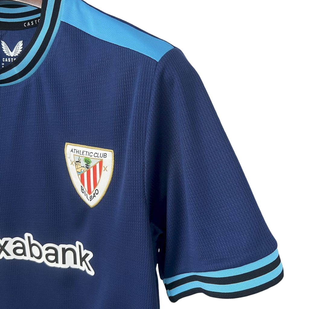 camisa-atlhetic-bilbao-il-2025-26-torcedor-masculina-camiseta-champions-league-lancamento-europeu-segunda-away-oficial-kutxabank-castore-azul-escuro-azul-claro-gola-azul-manga-azul