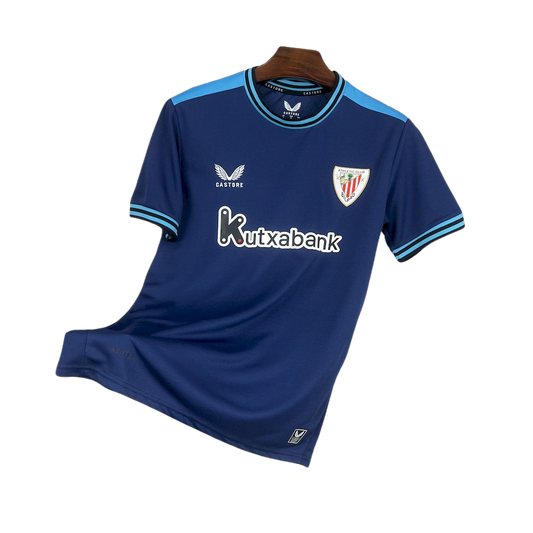 camisa-atlhetic-bilbao-il-2025-26-torcedor-masculina-camiseta-champions-league-lancamento-europeu-segunda-away-oficial-kutxabank-castore-azul-escuro-azul-claro-gola-azul-manga-azul